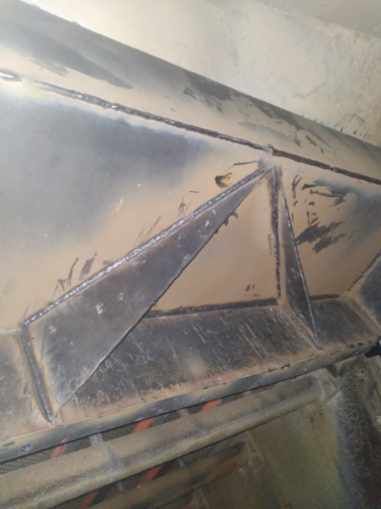 A close up of a metal structure with a triangle on it.