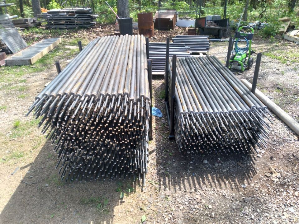 A bunch of metal pipes are stacked on top of each other