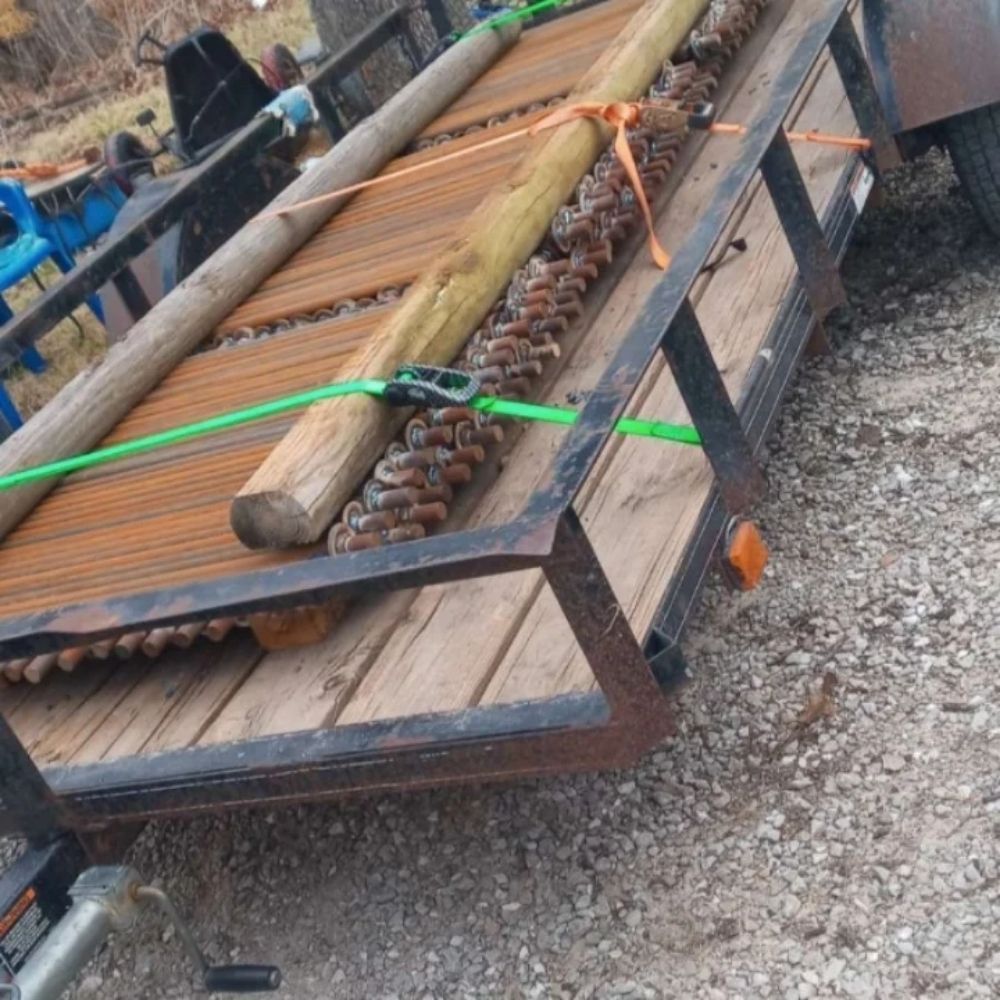 A trailer with a bunch of logs on it