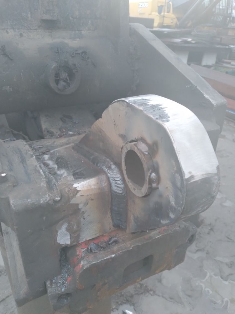 A piece of metal is sitting on top of a wooden table.