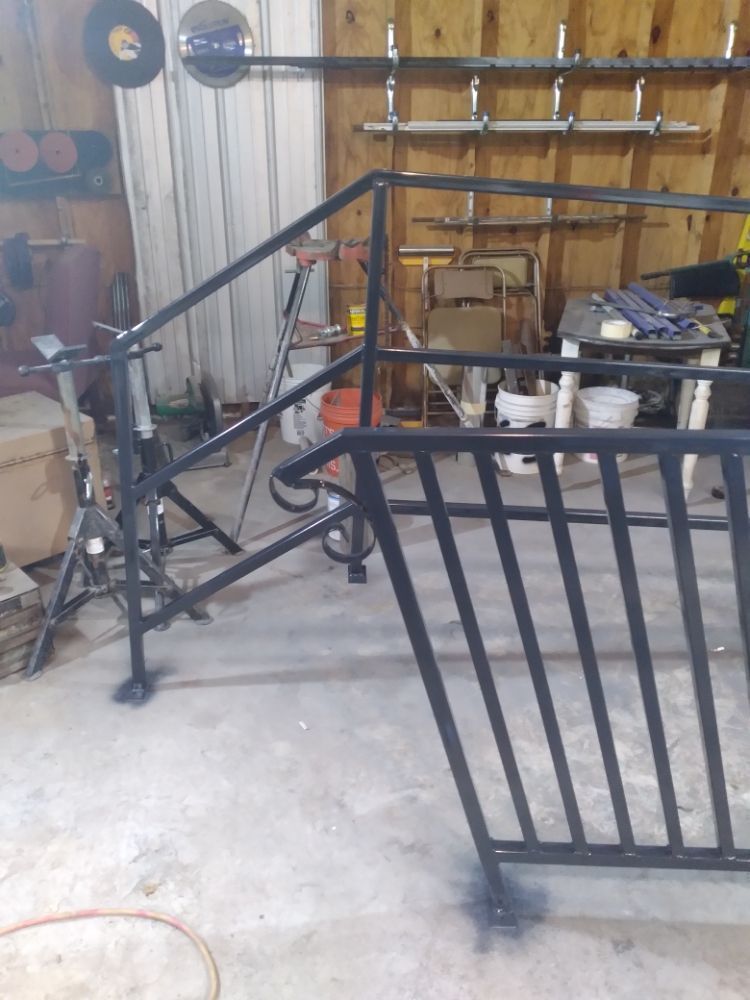 A metal railing is being built in a garage.