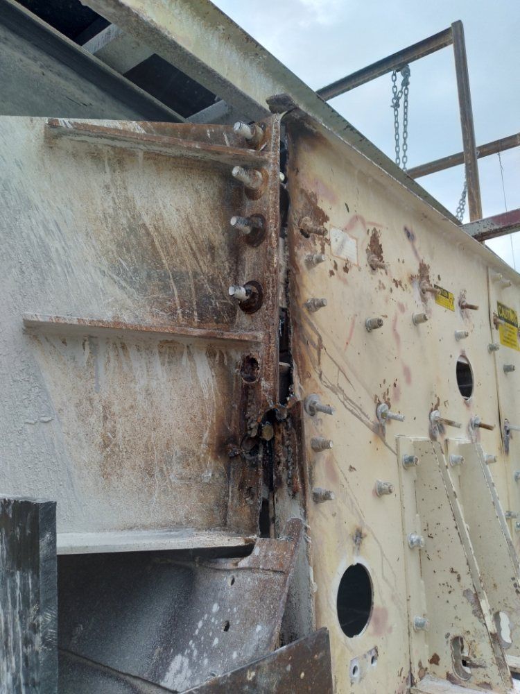 A close up of a rusty metal structure with a hole in the middle.