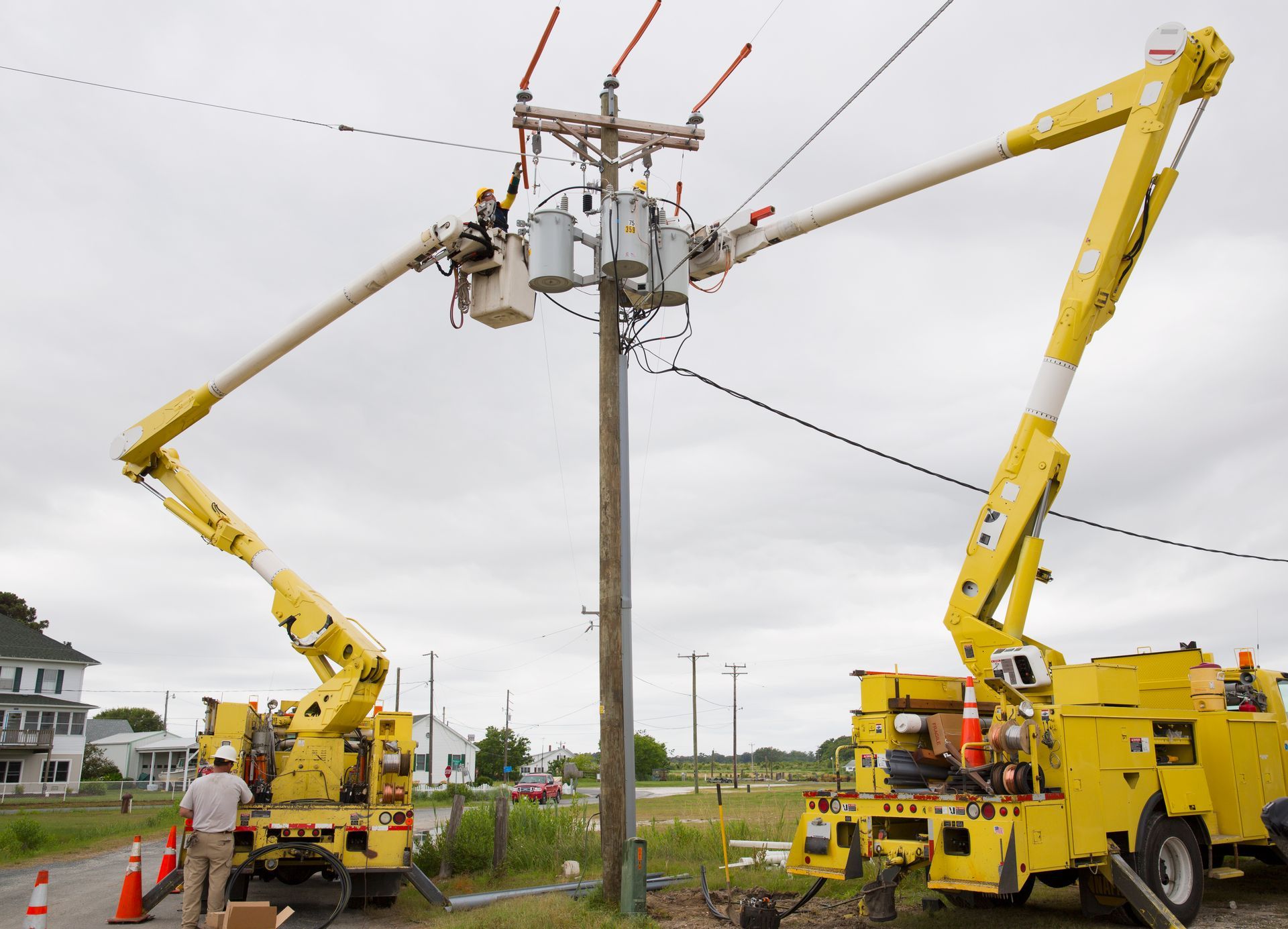 Electricians Using Cherry Pickers At Power Line — Newcastle, NSW — Mainlec Australia Pty Ltd