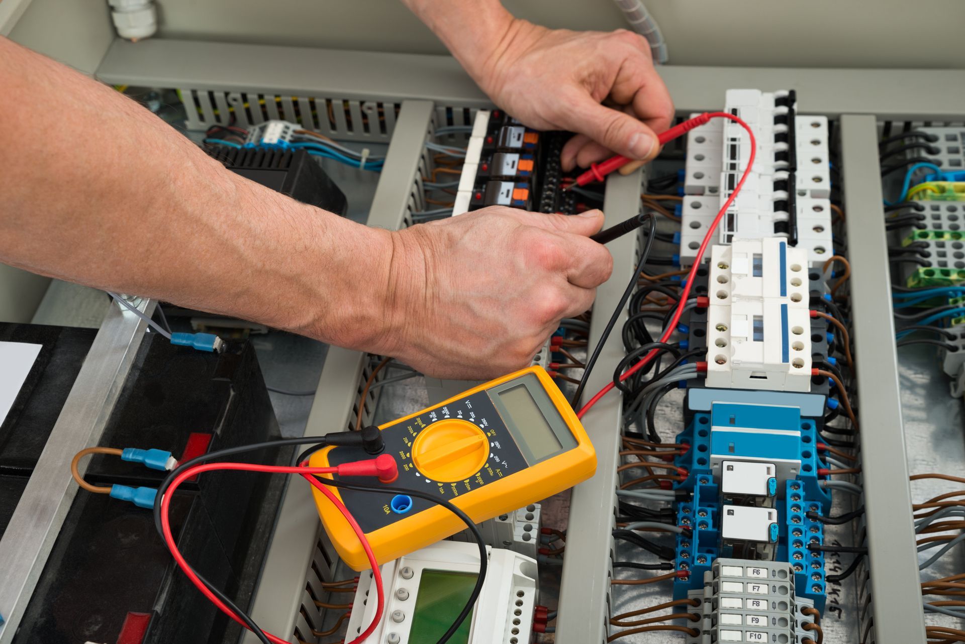 Electrician Checking A Fuse Box — Newcastle, NSW — Mainlec Australia Pty Ltd