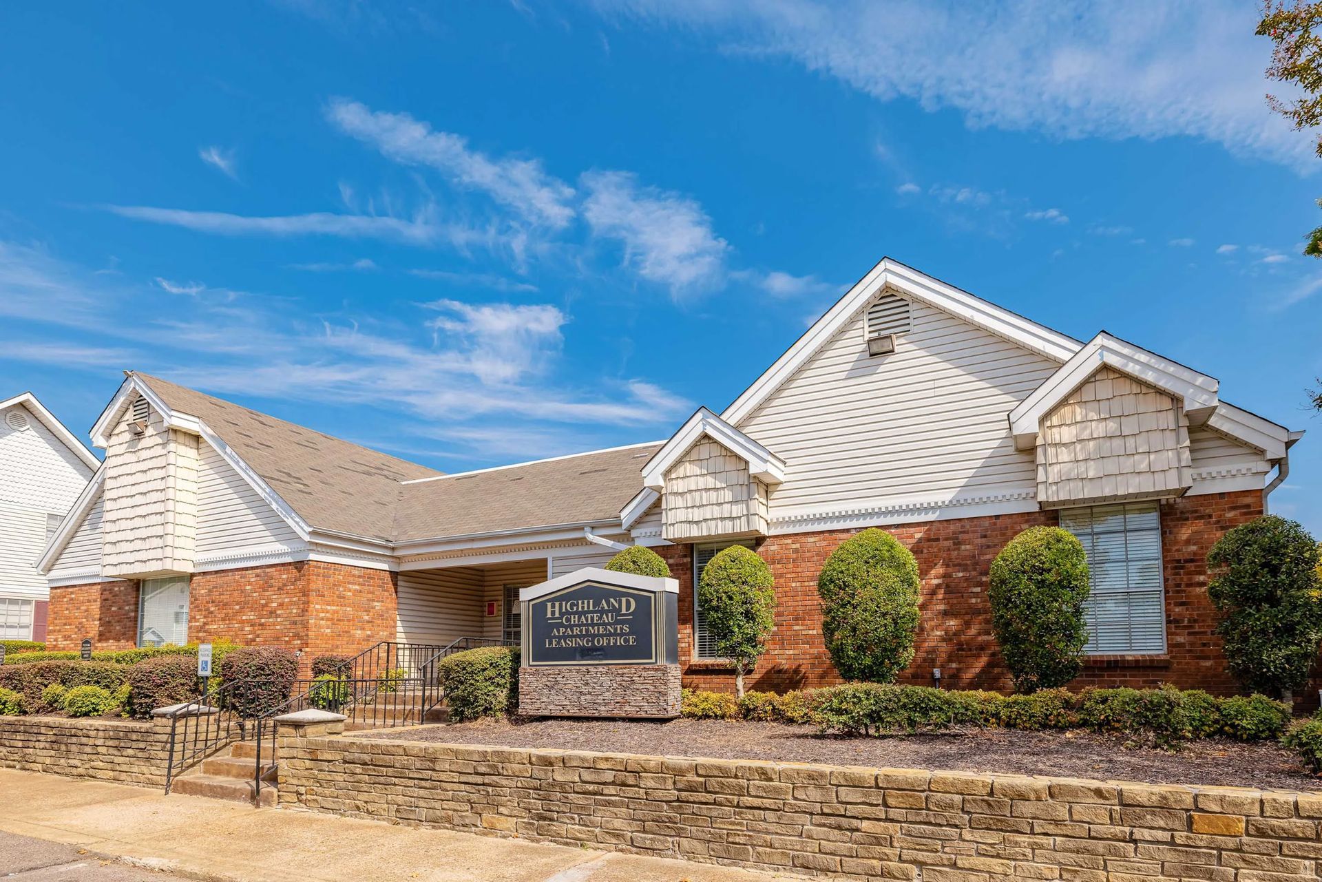 A large brick building with a sign in front of it.