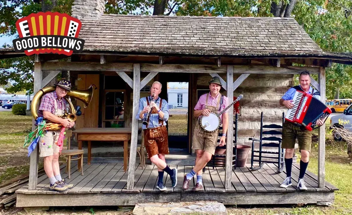 A group of men are standing on a porch playing instruments.