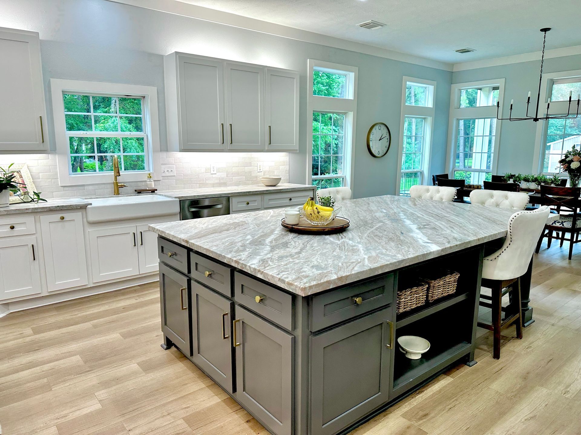 There is a large gray island in the middle of the kitchen.