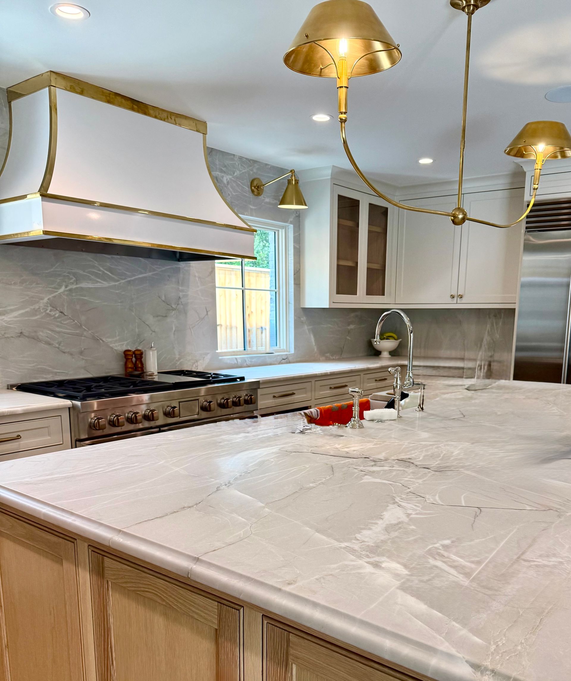 A kitchen with a stove top oven and a sink