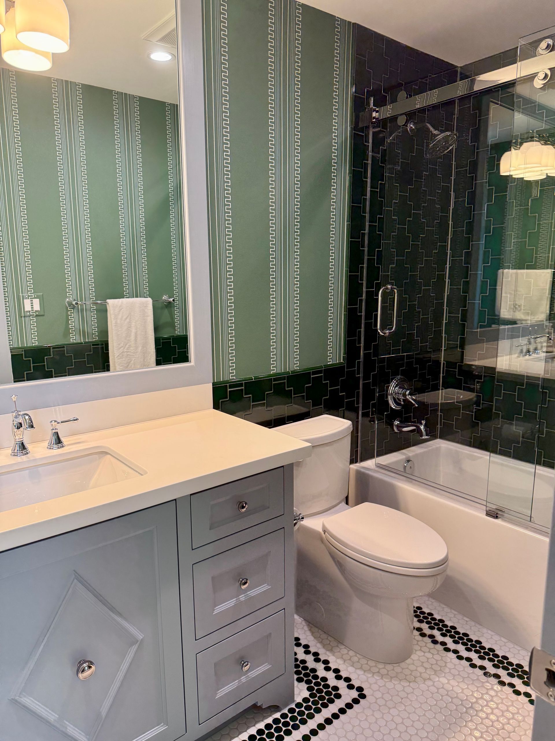 A bathroom with a toilet , sink , and bathtub.