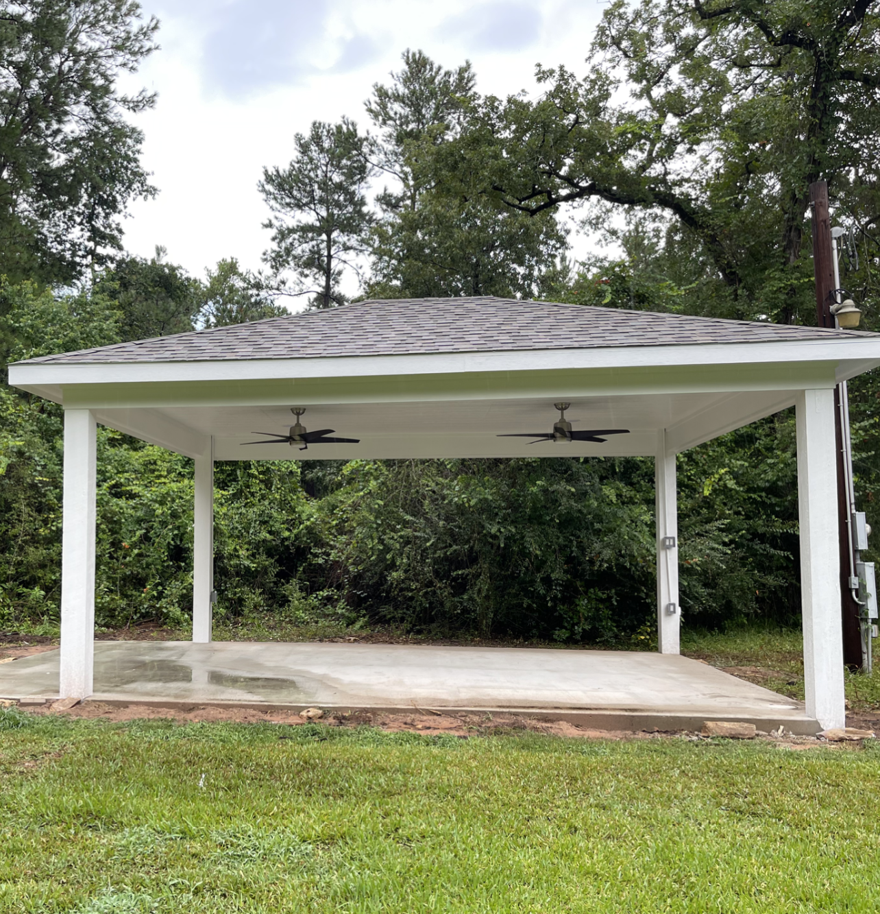 There are two ceiling fans on the roof of the pavilion.
