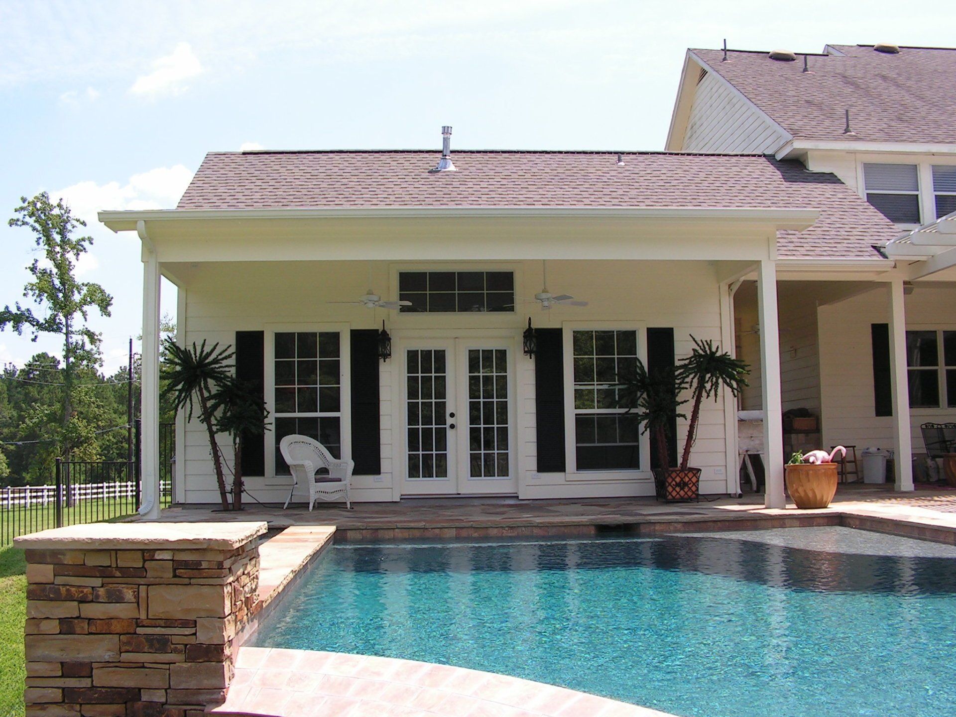 A house with a swimming pool in front of it