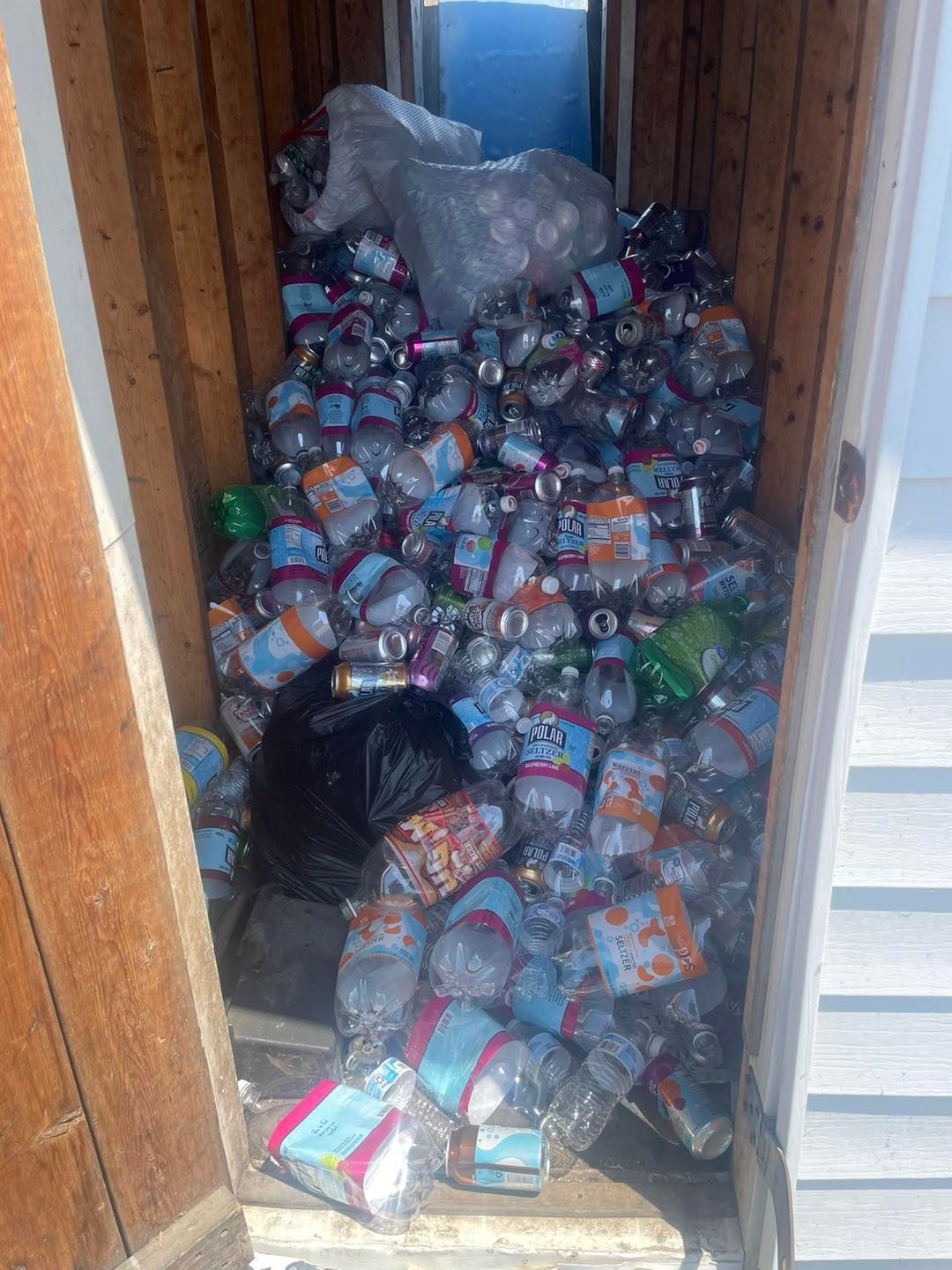 A room filled with lots of plastic bottles and cans.