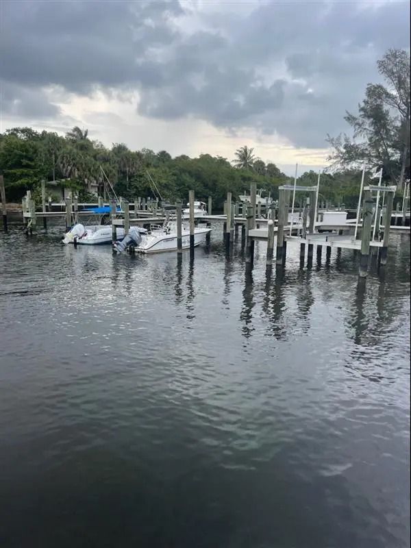 A boat is docked at a dock in the middle of a body of water.