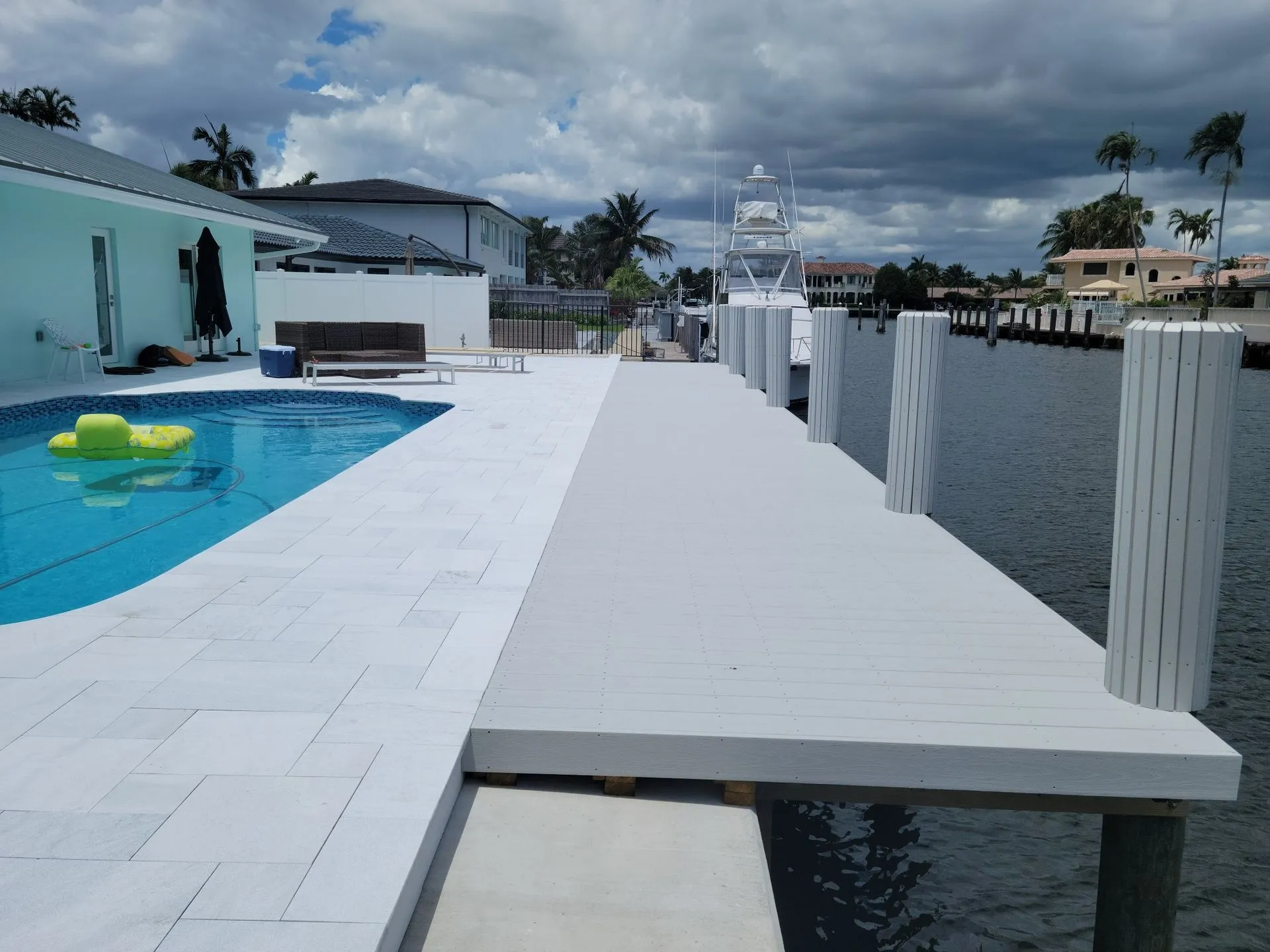 A dock with chairs on it overlooking a body of water