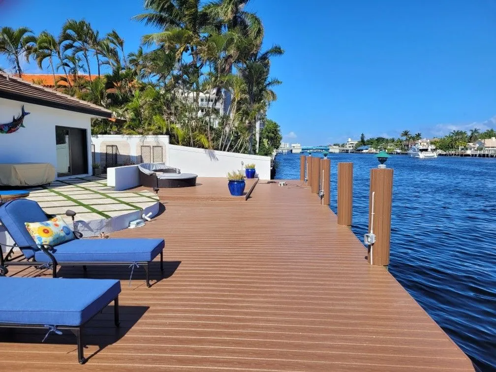 A dock with chairs on it overlooking a body of water