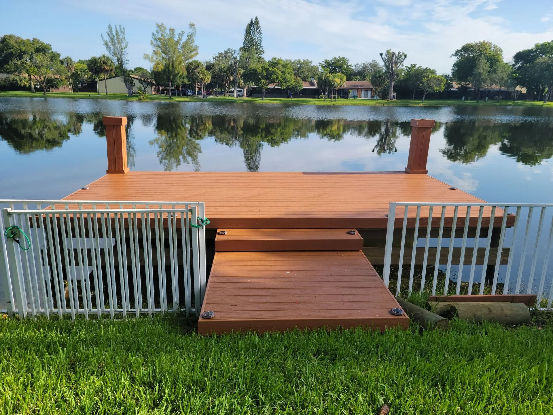 A wooden dock with stairs leading to a lake