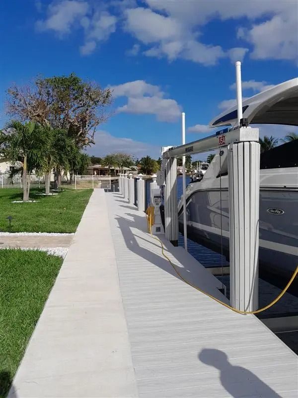 A boat is docked at a dock on a sunny day