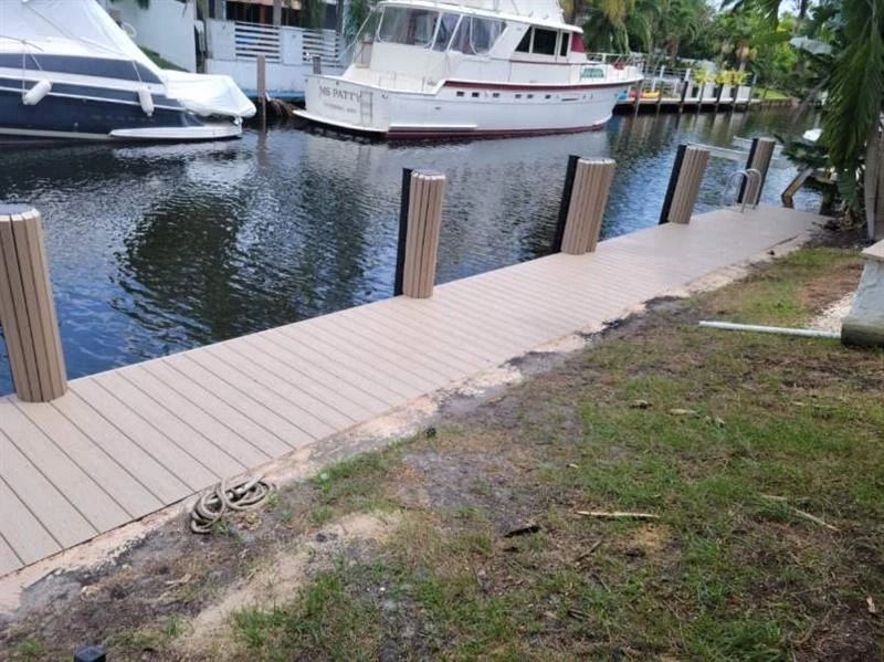 A boat is docked on a dock next to a house