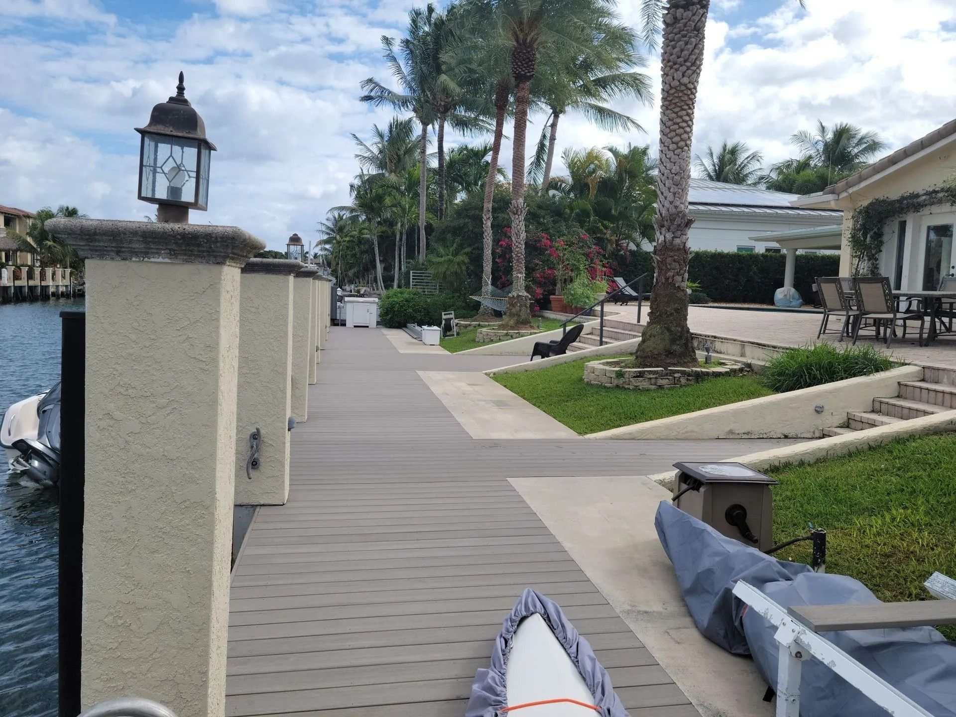 A boat is docked on a dock next to a house