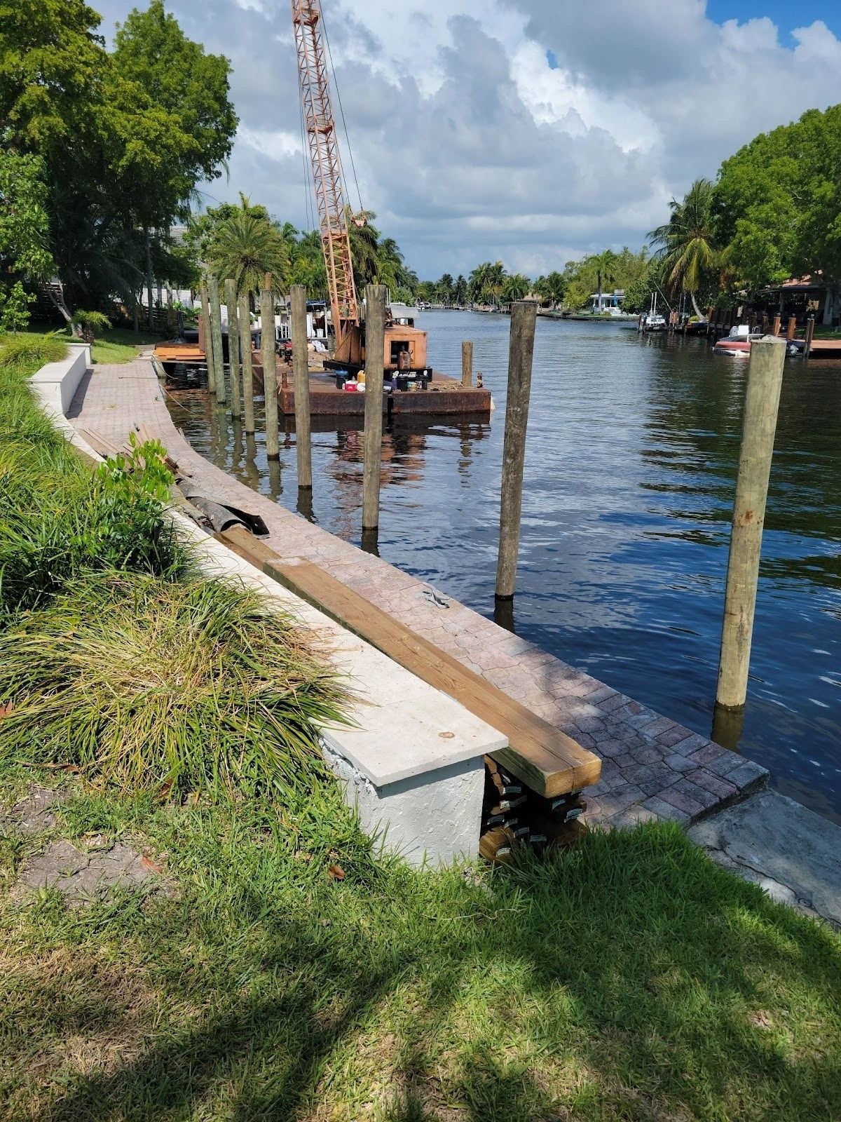 A wooden dock is being built next to a body of water.