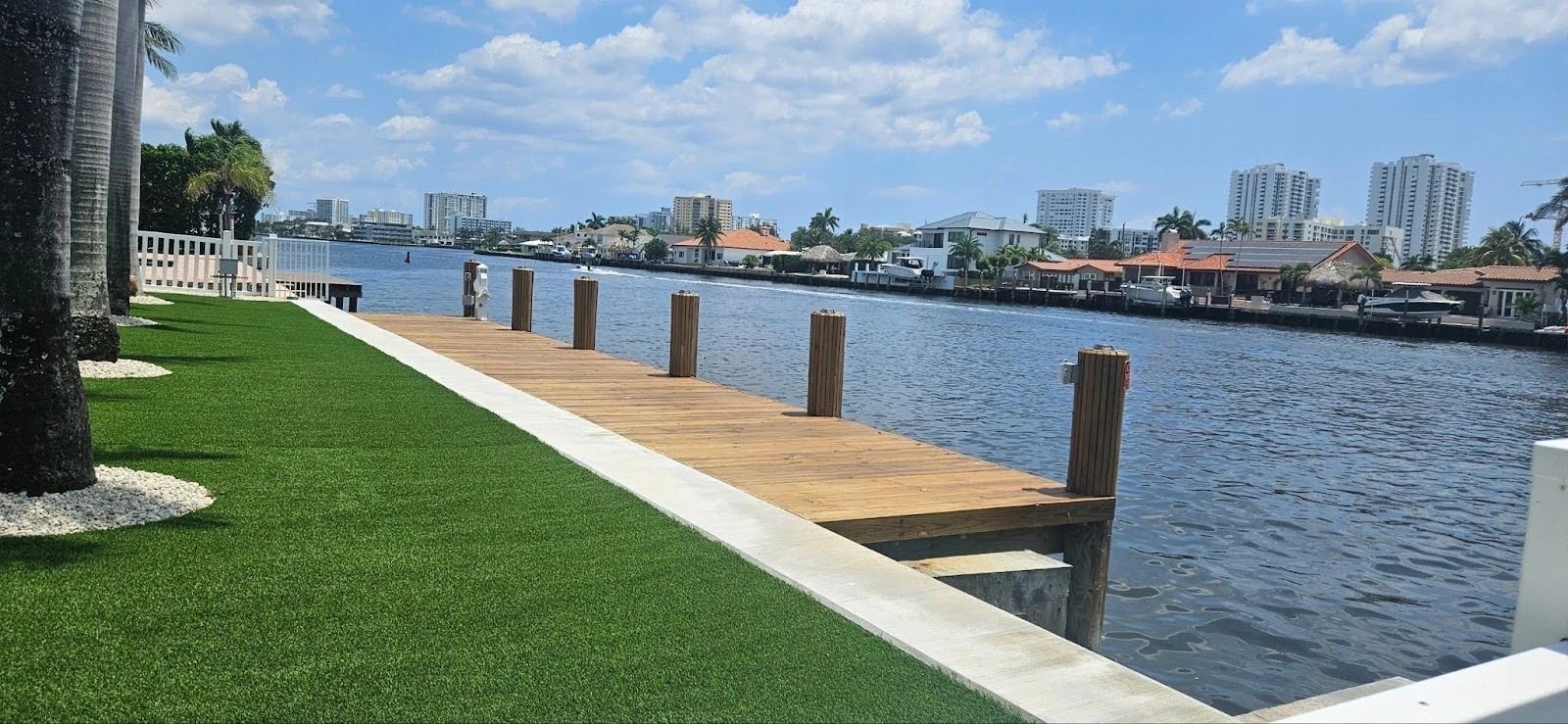 A wooden dock is sitting next to a body of water.