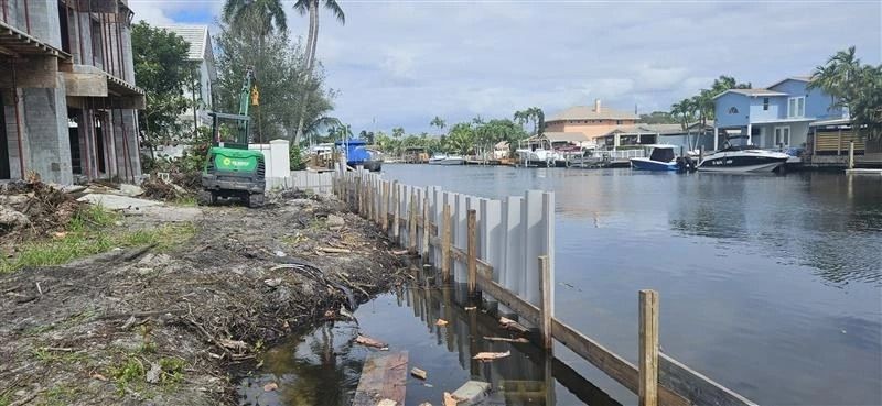 A wooden dock is being built next to a body of water.