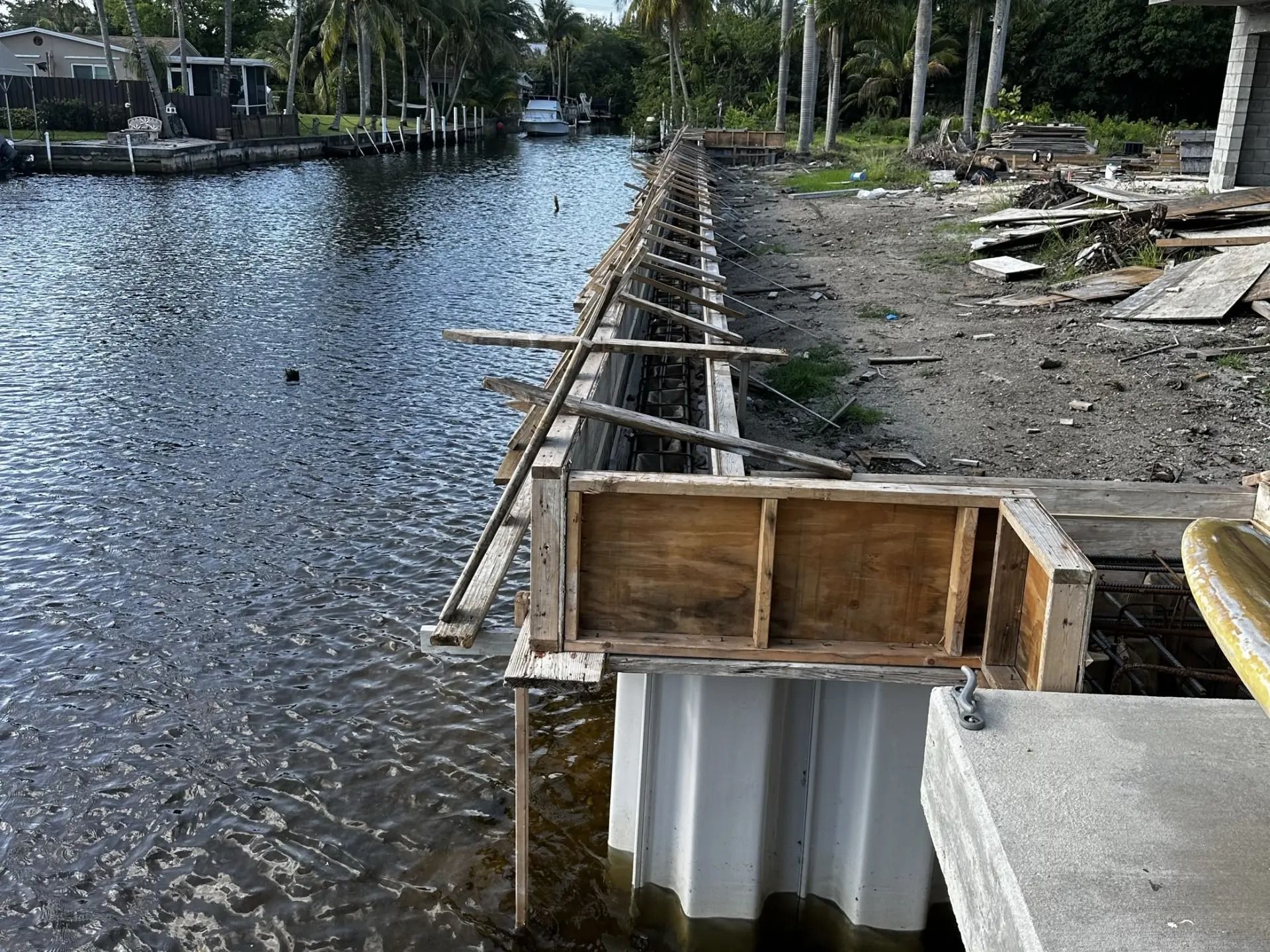 A dock with chairs on it overlooking a body of water