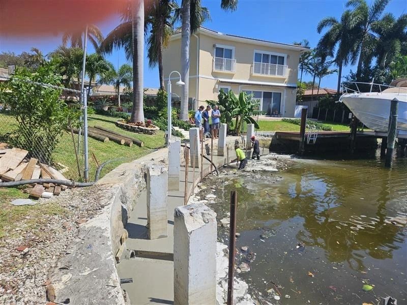 A boat is docked in the water near a house