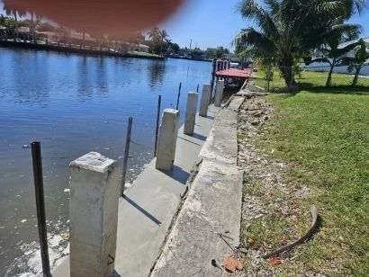 A wooden dock with stairs leading to a lake