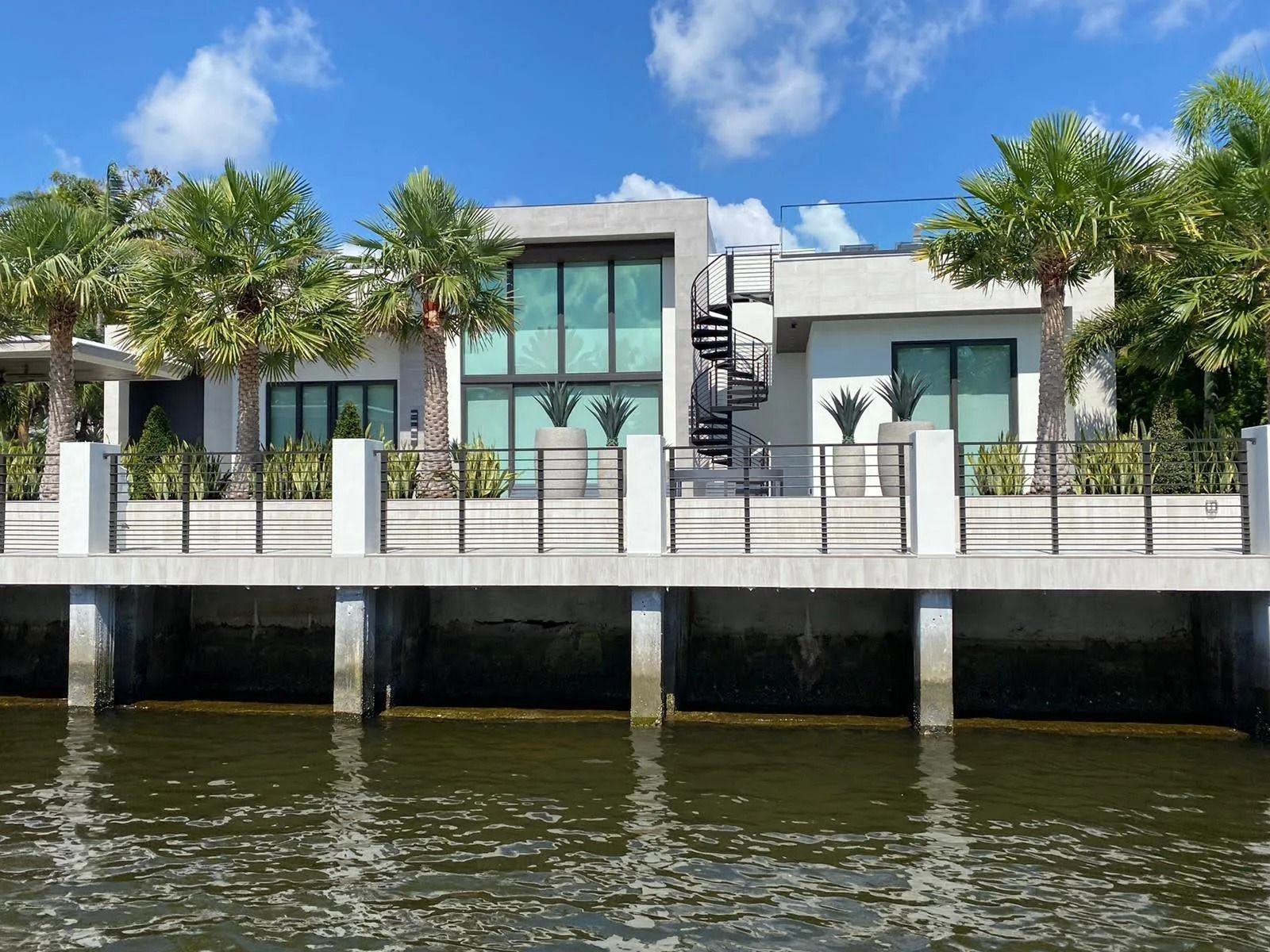 A dock with chairs on it overlooking a body of water