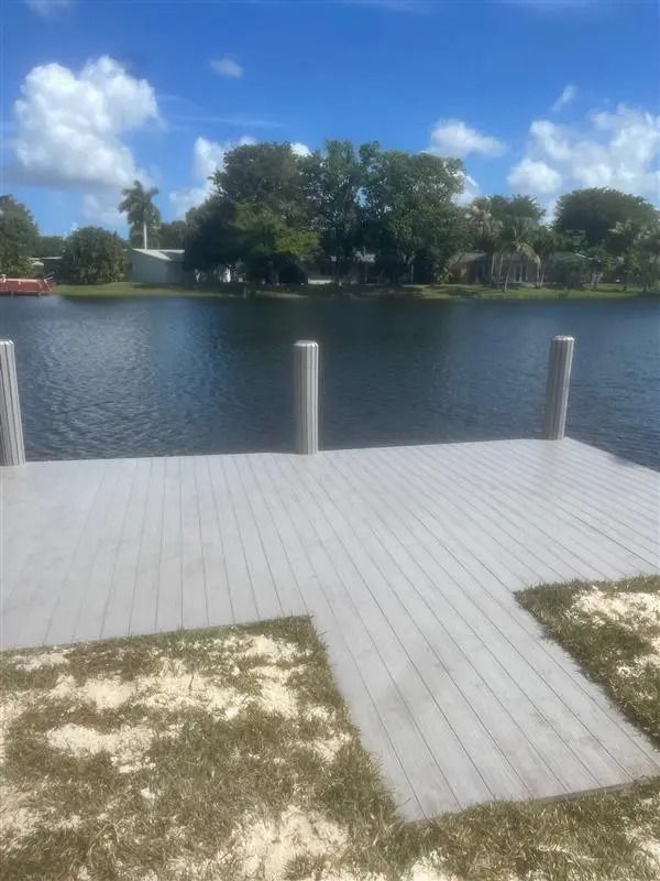 A large body of water with a dock in the foreground