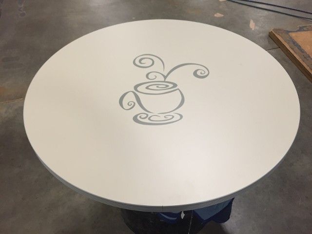A round table with a cup of coffee on it