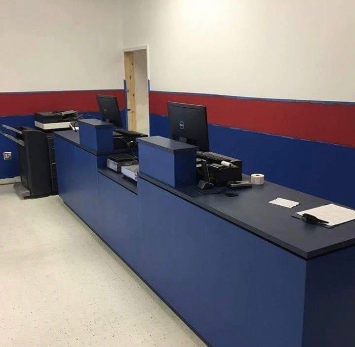 A laundry room with red and white walls and a counter