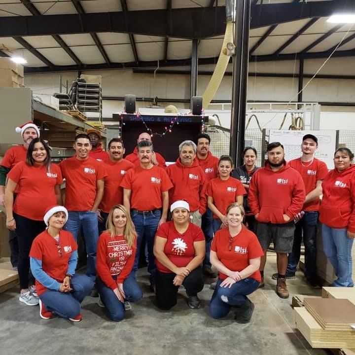 A group of people in red shirts are posing for a picture