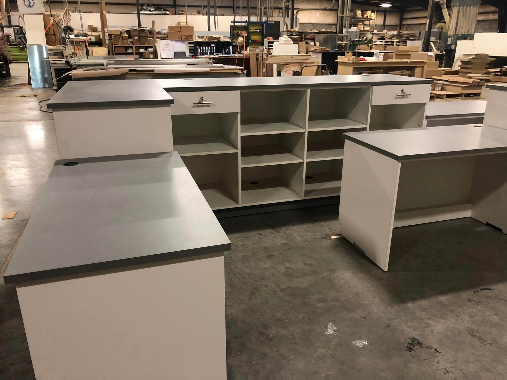A warehouse filled with lots of desks and shelves