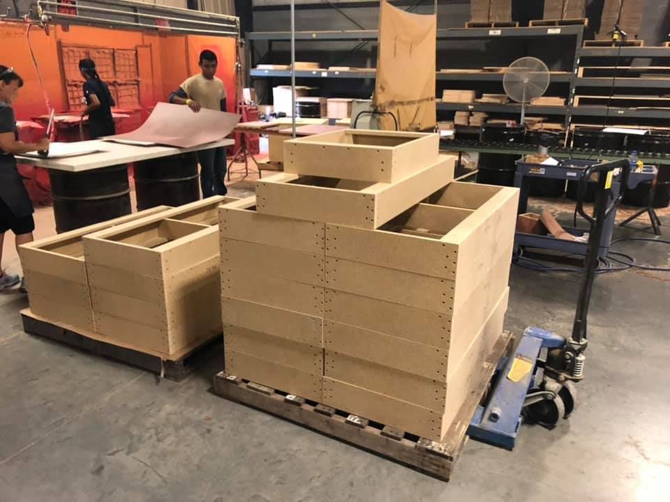 A group of wooden boxes are stacked on top of each other in a warehouse.