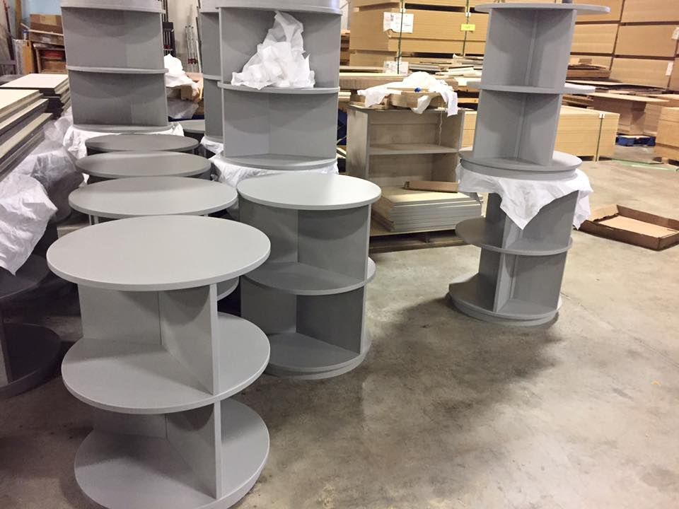 A bunch of round shelves are stacked on top of each other in a warehouse