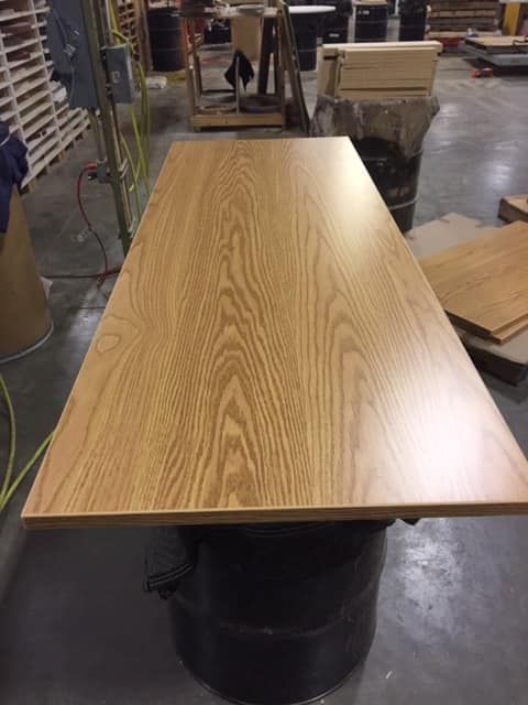 A kitchen with a desk and cabinets in a showroom