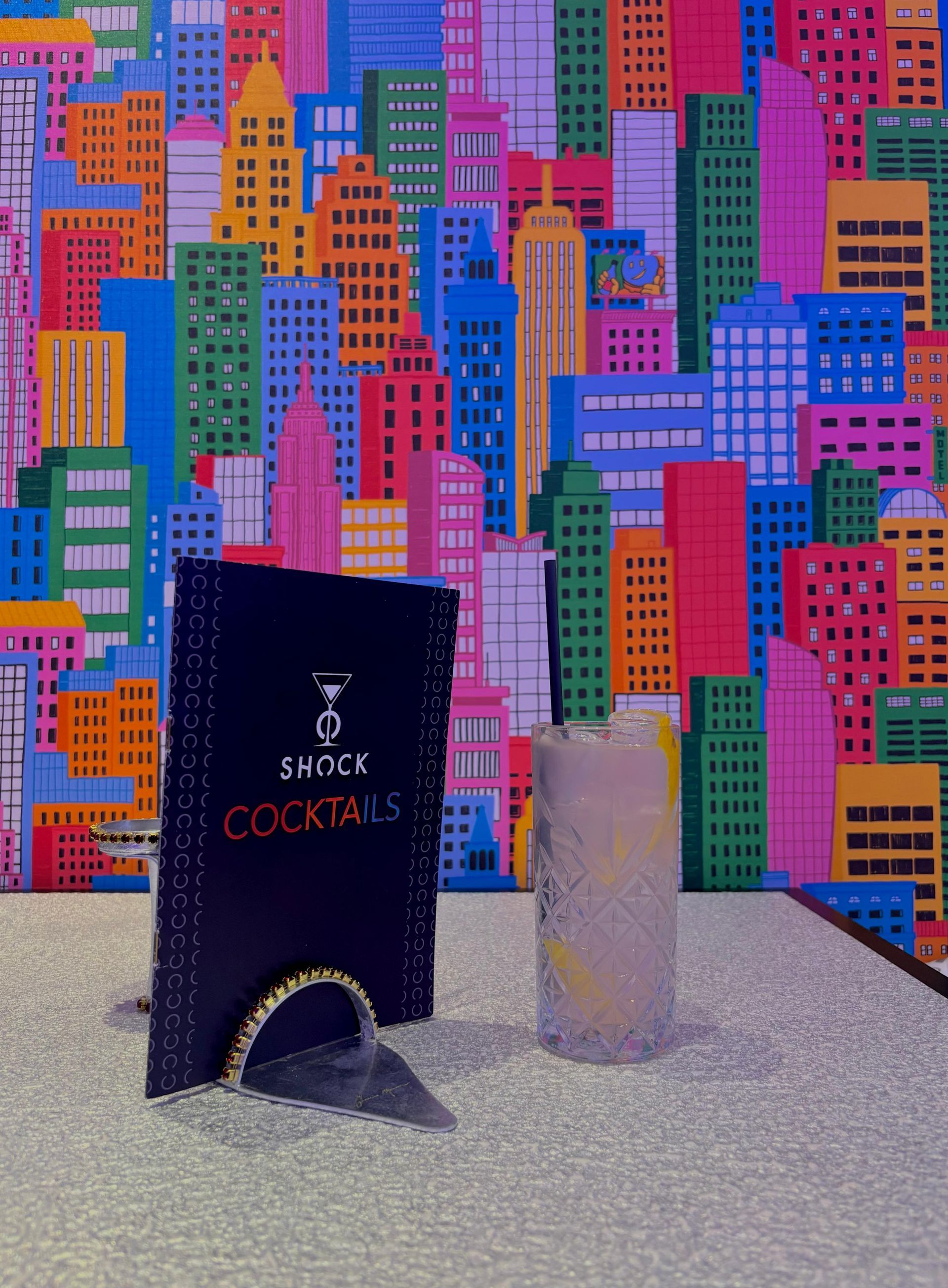 Un ristorante con tavoli e sedie e scaffali pieni di bottiglie di vino.