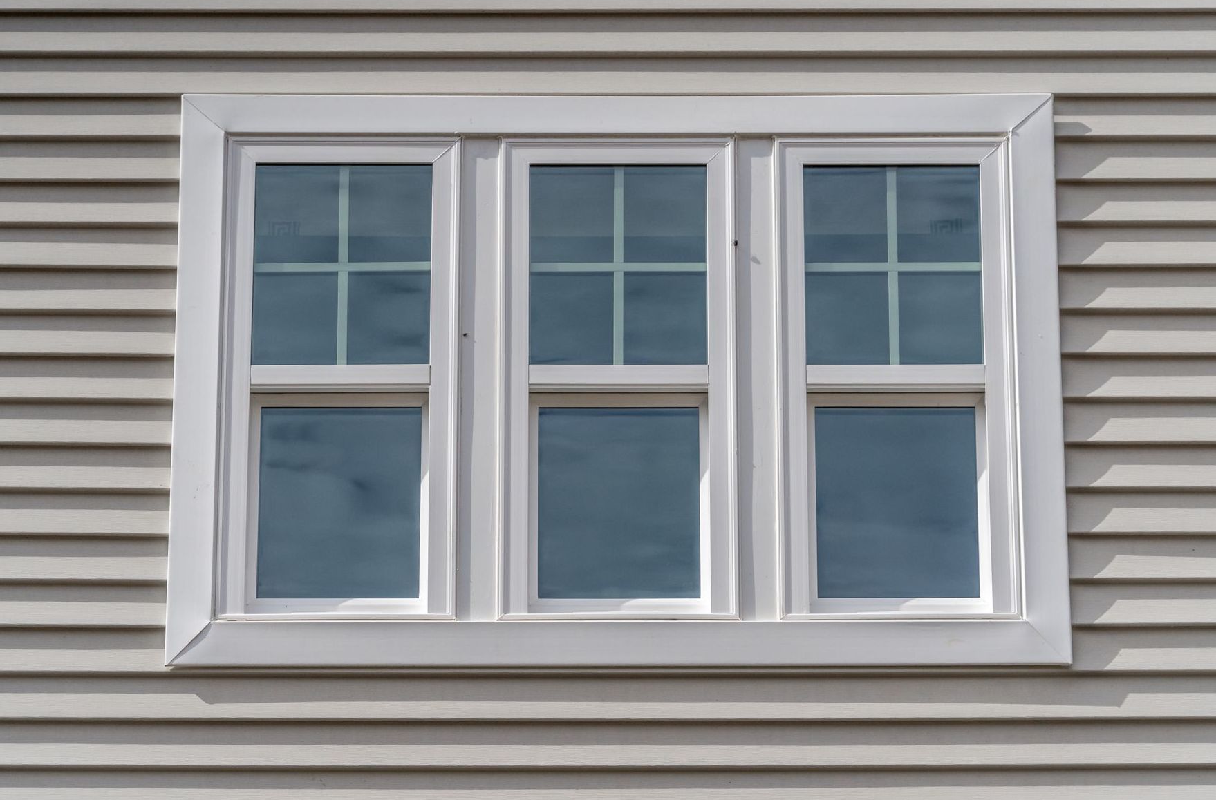 A close up of a window on the side of a house.