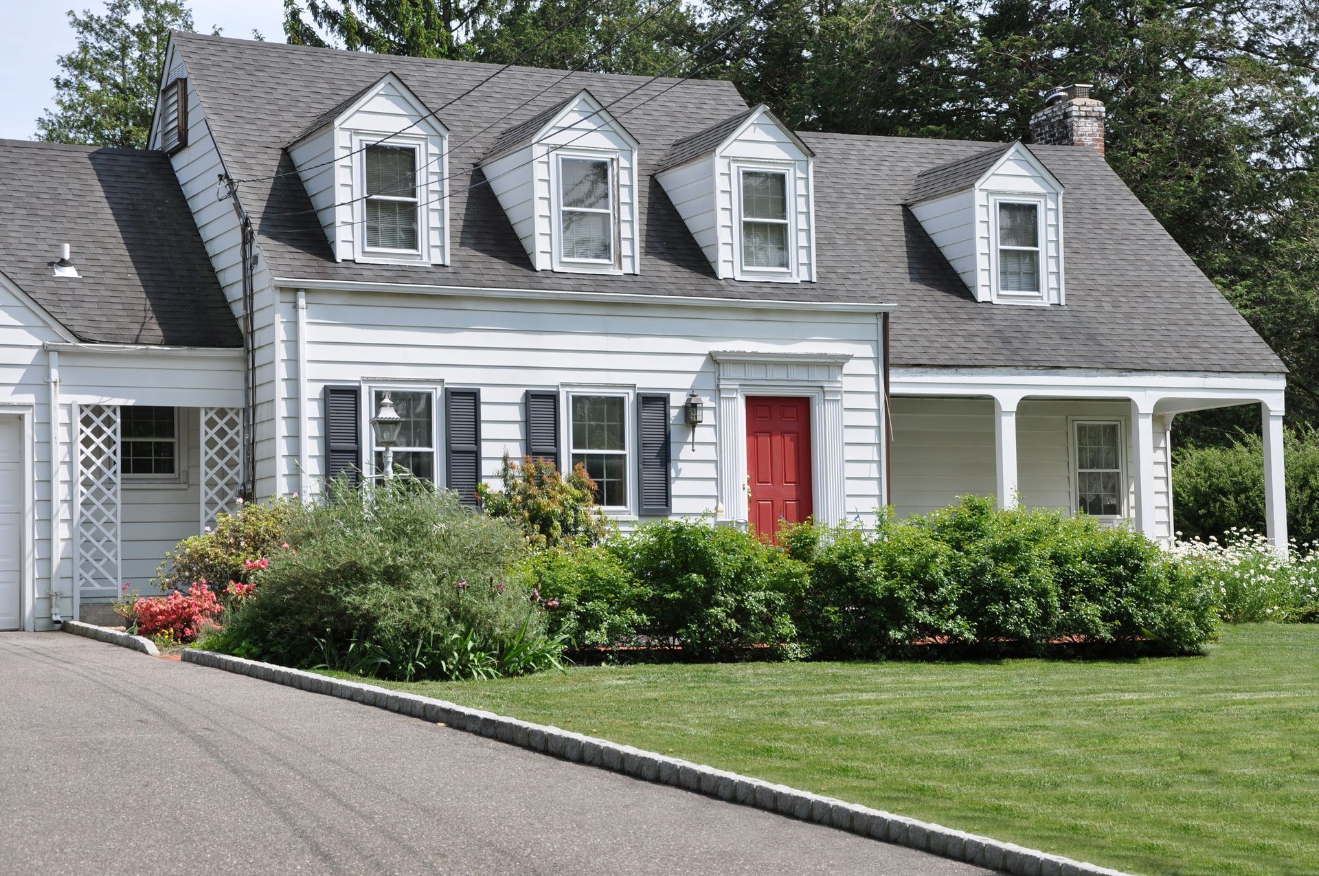 A white house with a red door and black shutters