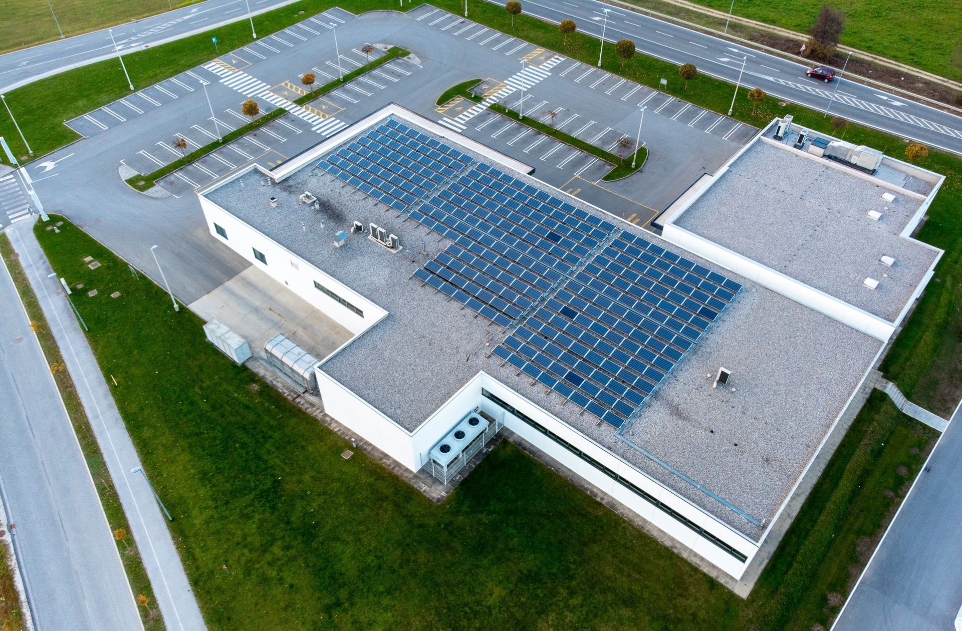 An aerial view of a building with solar panels on the roof.