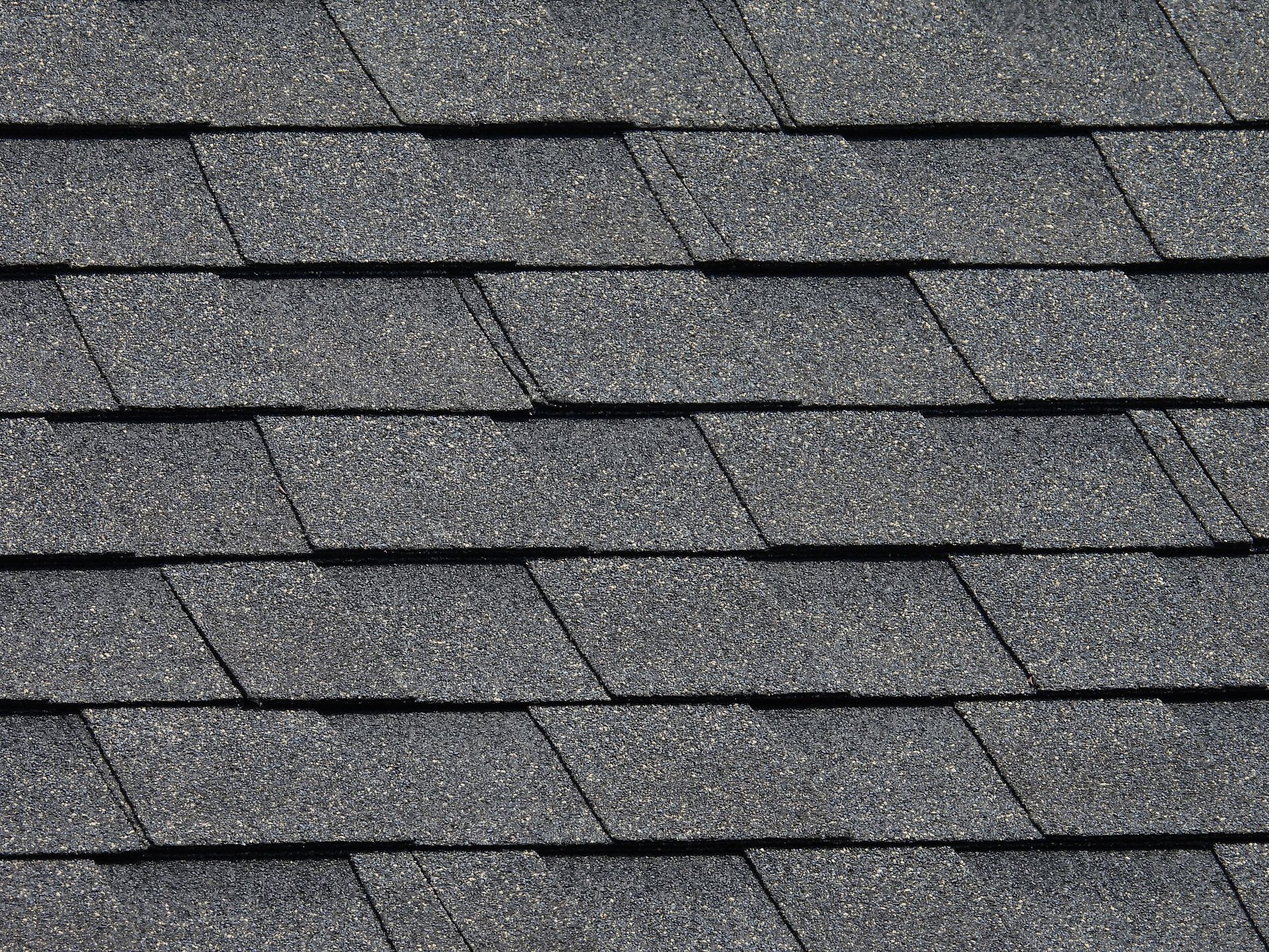 A close up of a roof with a lot of shingles on it.