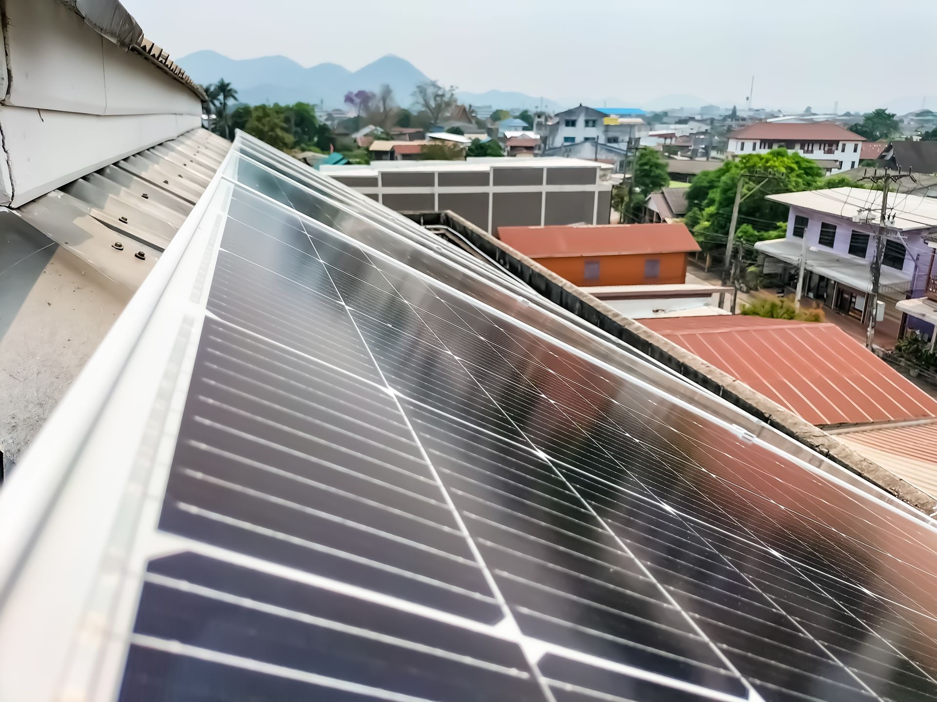 A row of solar panels on the roof of a building