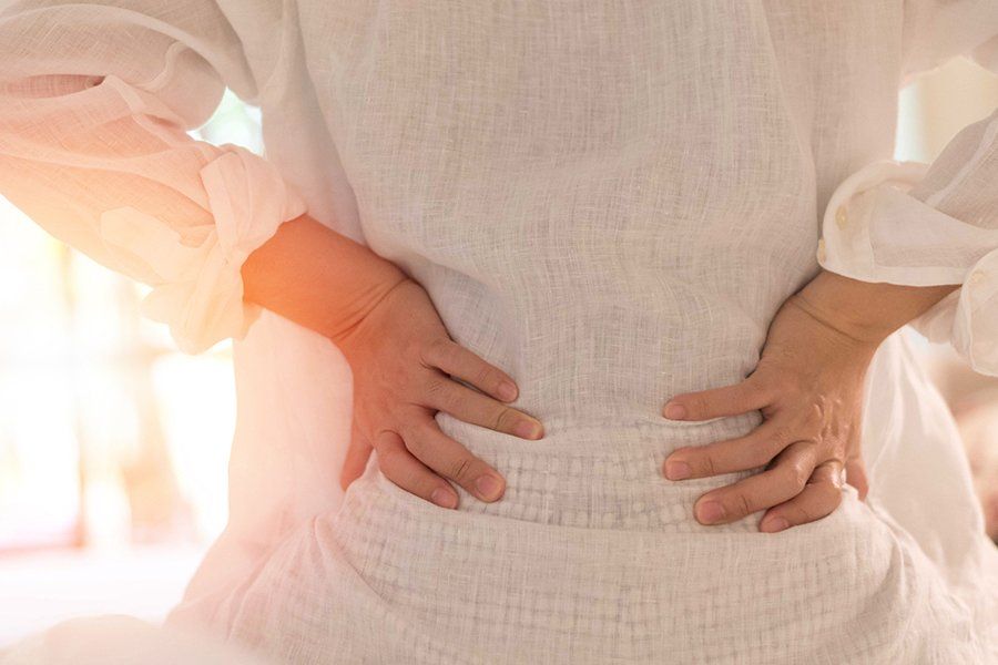 Woman Experiencing Back Pain — Fair Oaks, CA — Corner Chiropractic Center