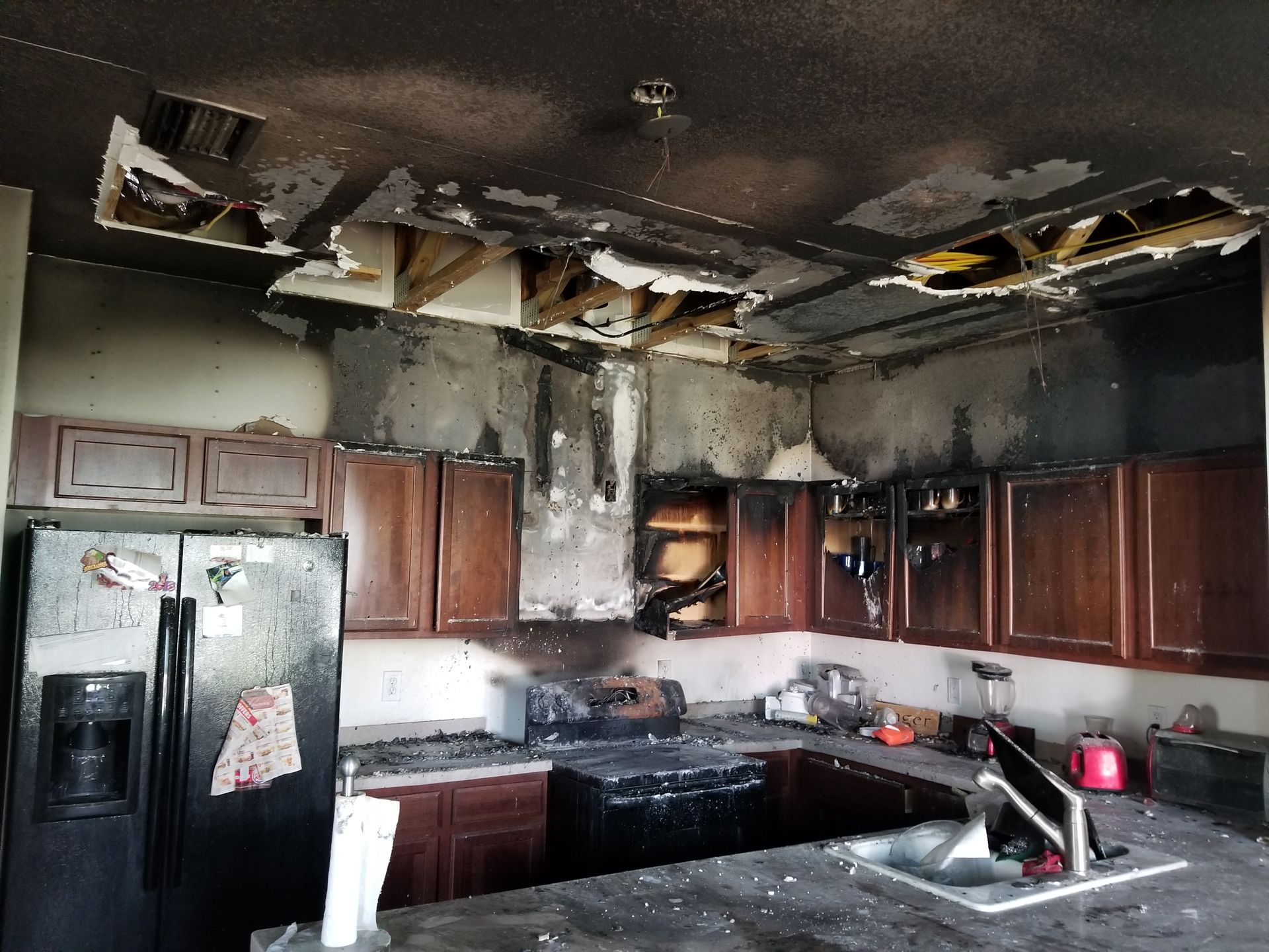 A kitchen that has been damaged by a fire