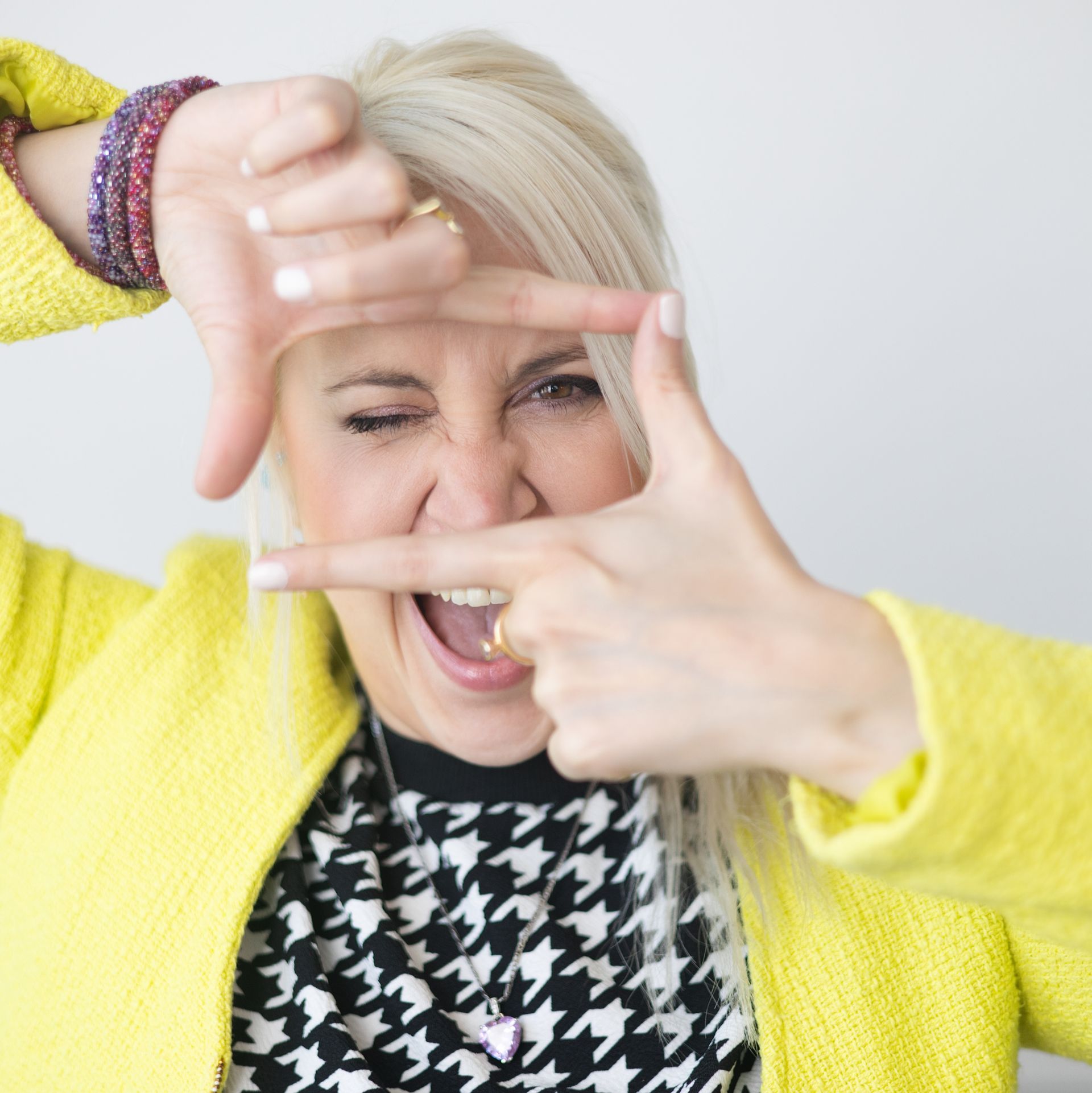 A woman in a white dress is holding a bouquet of blue flowers.