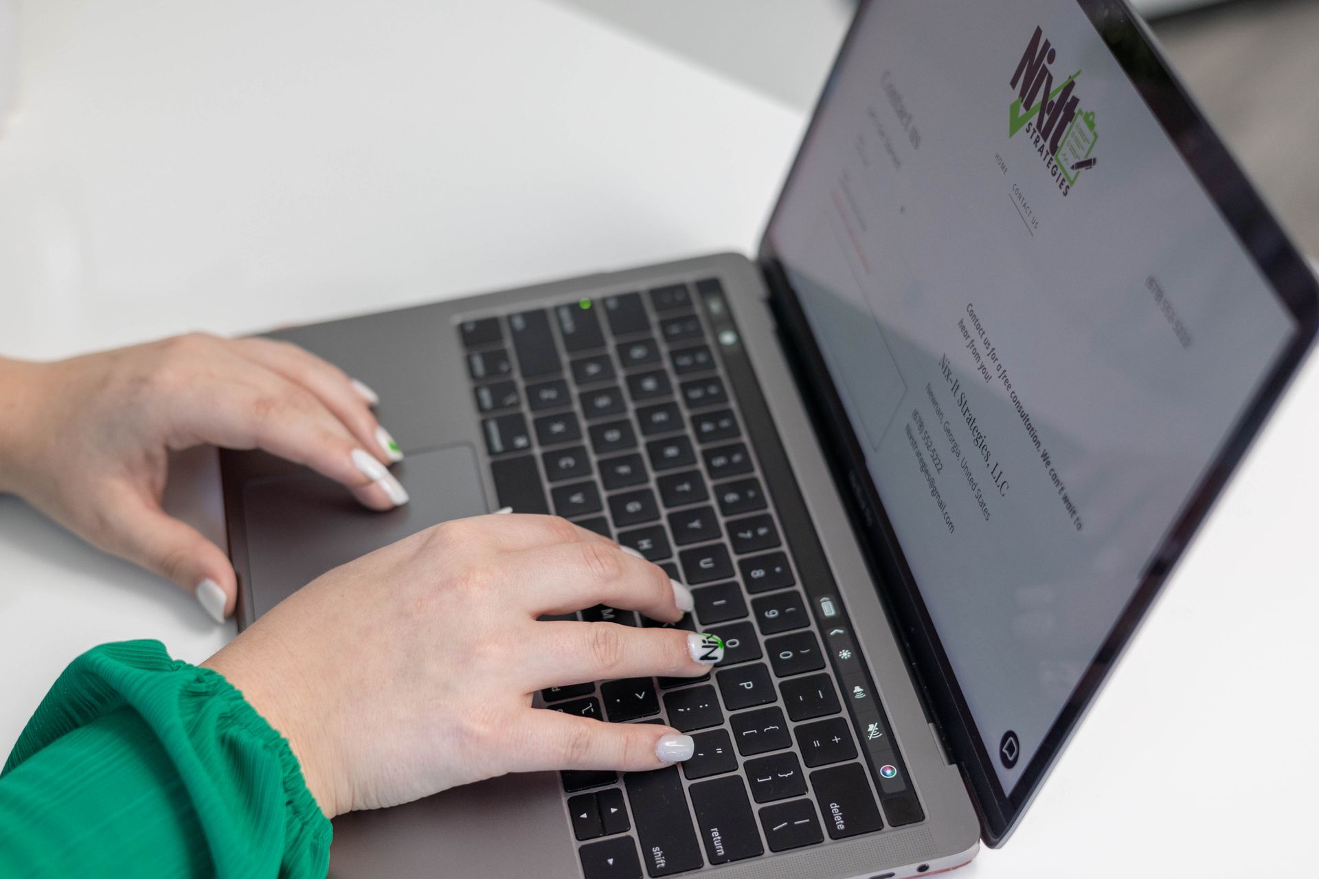 A person is typing on a laptop computer.