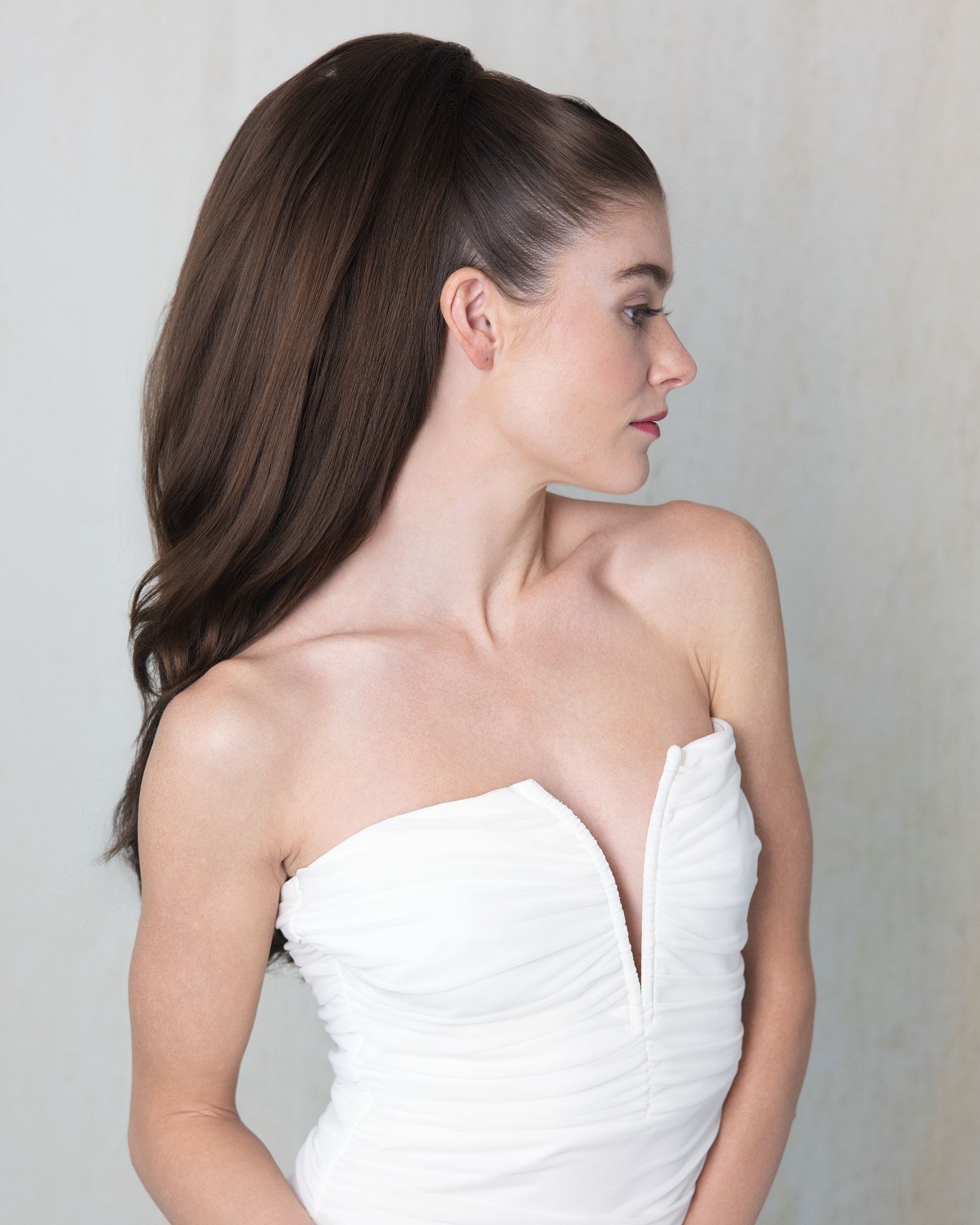 A woman with a flower crown on her head is smiling