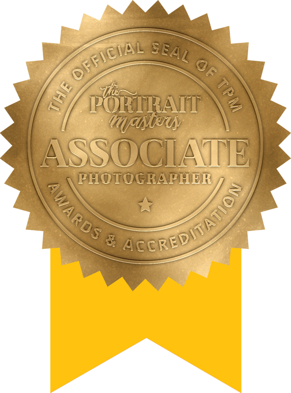 A gold seal that says portrait masters associate photographer awards & accreditation